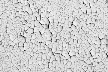 White peeling paint on the wall. Old concrete wall with cracked flaking paint. Weathered rough...