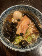 A bowl of ramen with slice of pork.