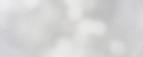 close up on white plain wall background texture with shadow of window from sunlight for ads and...