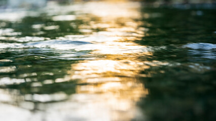 Light reflection on flowing water surface