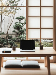 A laptop sits on a wooden desk in front of a window