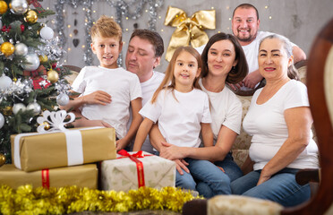 Big family is celebrating New Year together and talking at table indoors
