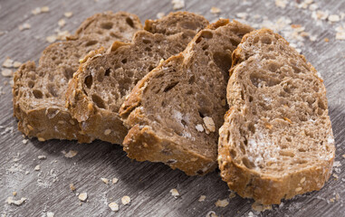 Fresh slices of rye bread on wooden surface