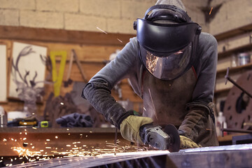 Welding Sparks Illuminate Workshop A Skilled Metalworker Engaged in Intensive Work