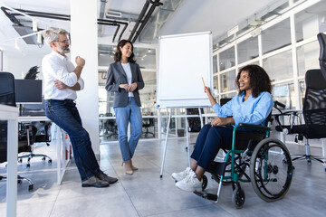 Executive woman with disability in wheelchair in office giving presentation on strategy