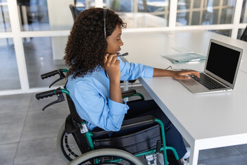 Disabled woman agent in wheelchair with microphone and headset assists clients