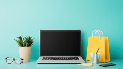 Fototapeta premium A laptop on a turquoise desk with glasses, a potted plant, a striped cup, and a yellow shopping bag.