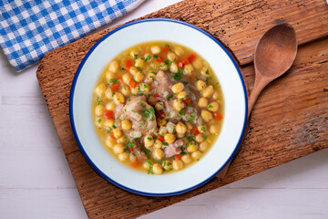 Chickpea stew with pig trotters. Top view table with  decorations.