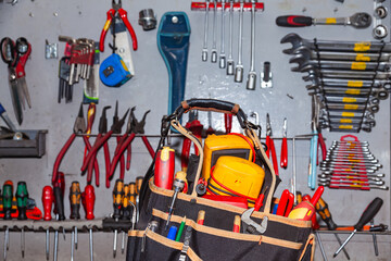 Fototapeta premium An electrician's bag full of tools stands in the workshop.