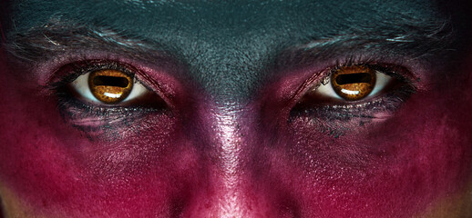 Closeup man eyes with holiday mascaraed makeup. Concept of Halloween, makeup. supernatural...