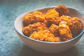 Laksa Popcorn chicken with Laksa Mayonnaise Dip served in a bowl.