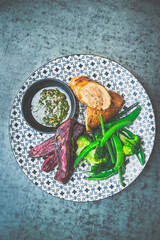 Roasted Chicken Roulade Roasted sweet potatoes, steamed green vegetables, chimichurri sauce .