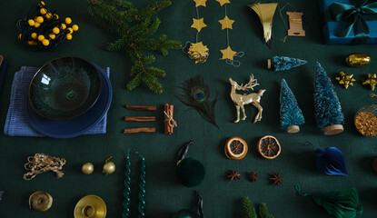 Christmas festive preparation concept flat lay on the green linen fabric. Xmas objects for table and tree decoration