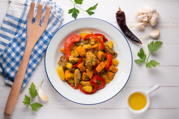 Stir-fried chicken with sweet potato and red pepper. Top view table with  decorations.