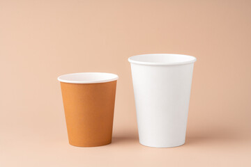 Disposable coffee cups arranged on a neutral background