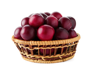 Fresh ripe plums in wicker bowl isolated on white