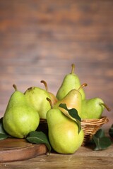 Fresh green pears and leaves on wooden table. Space for text
