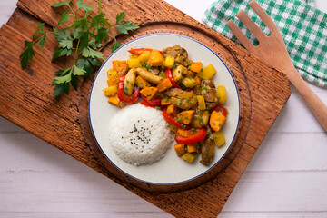 Stir-fried chicken with sweet potato and red pepper. Top view table with  decorations.