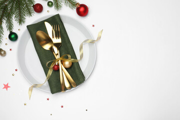 Christmas table setting with plate, cutlery, napkin and festive decor on white background, flat...