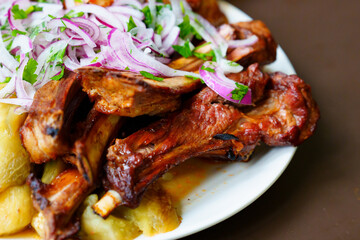 Grilled ribs with marinated onions and grilled vegetables. 
