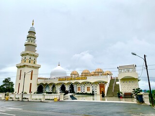 The mosque is white with a large minaret on top.