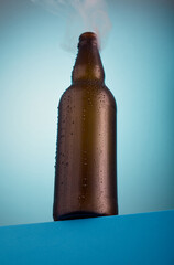 Brown beer bottle on a blue gradient background.