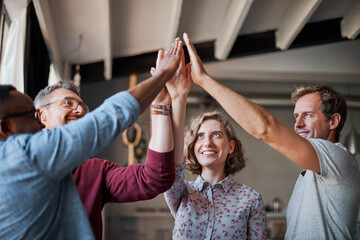 Employees, high five and hands in huddle for plan, teamwork and diversity in company mission....