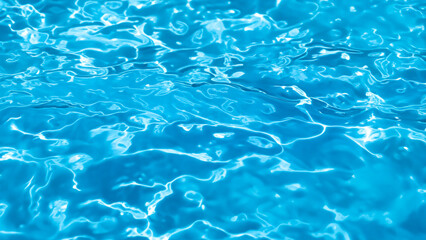 Obraz premium Bright Blue Water Surface Texture in Swimming Pool with Sunlight Reflections