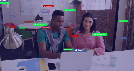 Image of social media icons with texts over diverse colleagues discussing work in office