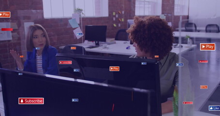 Image of social media icons with texts over diverse colleagues discussing work in office