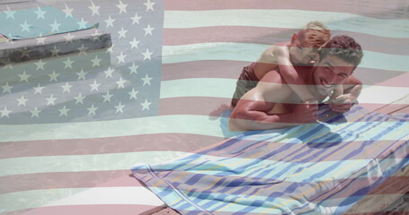 Image of american flag over happy caucasian father and son playing in sunny pool