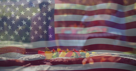 Fototapeta premium Image of american flag over food on barbecue and diverse friends celebrating outdoors