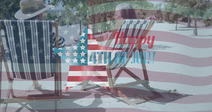 Image of happy 4th of july text and usa flag over senior caucasian couple holding hands on beach