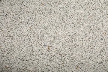 Clean clay cat litter as background, top view