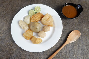 A plate of Siomay Bandung. Usually consists of dimsum, potatoes, meatball, steamed cabbage, topped with peanut sauce and a little lime.