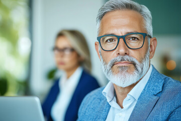 Fototapeta premium A confident businessman in a blue blazer looks directly at the camera.