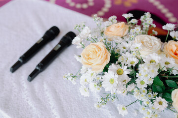2 black microphone and bouquet of flowers, wedding celebration concept