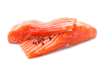Pieces of fresh salmon with peppercorns isolated on white