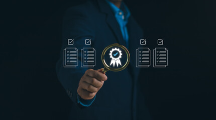 Concept of quality control, certification, warranty, service guarantee, businessman holding magnifying glass with best quality assurance management icon or compliance with regulatory requirement
