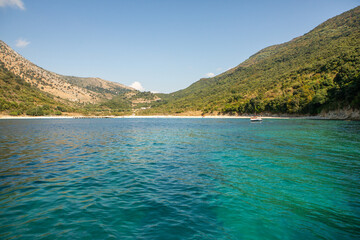 Obraz premium Very beautiful coastline on the Ionian Sea in Albania. The beach with fine sand in the mountains of Albania. Vacation at the sea.