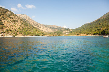 Very beautiful coastline on the Ionian Sea in Albania. The beach with fine sand in the mountains of Albania. Vacation at the sea.