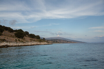 Very beautiful coastline on the Ionian Sea in Albania. The beach with fine sand in the mountains of Albania. Vacation at the sea.
