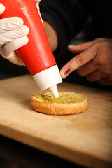 Stop motion of assembling burger. chef servering sauces on a burger bun. 