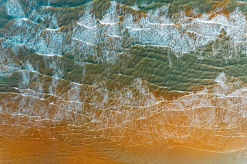 Blue sea waves and sand aerial photograph
