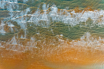 Blue sea waves and sand aerial photograph