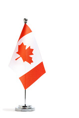 Canada flag on metal flagpole isolated on white background.