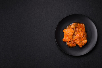 Sliced fish in tomato sauce with salt and spices