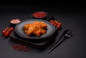 Sliced fish in tomato sauce with salt and spices