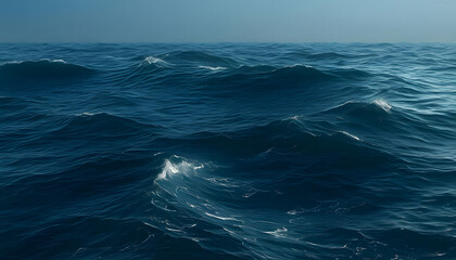Fototapeta premium Vast ocean waves in deep blue, calm sea under bright sky