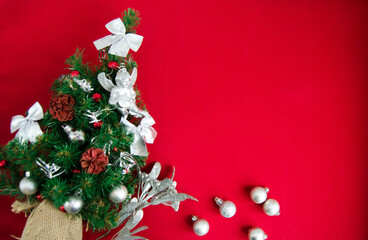 Christmas decorations on red background, flat lay. Space for text.